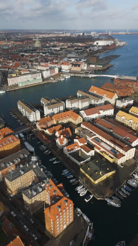 Vertical drone shot overlooking the downtown of Copenhagen, sunset in Denmark