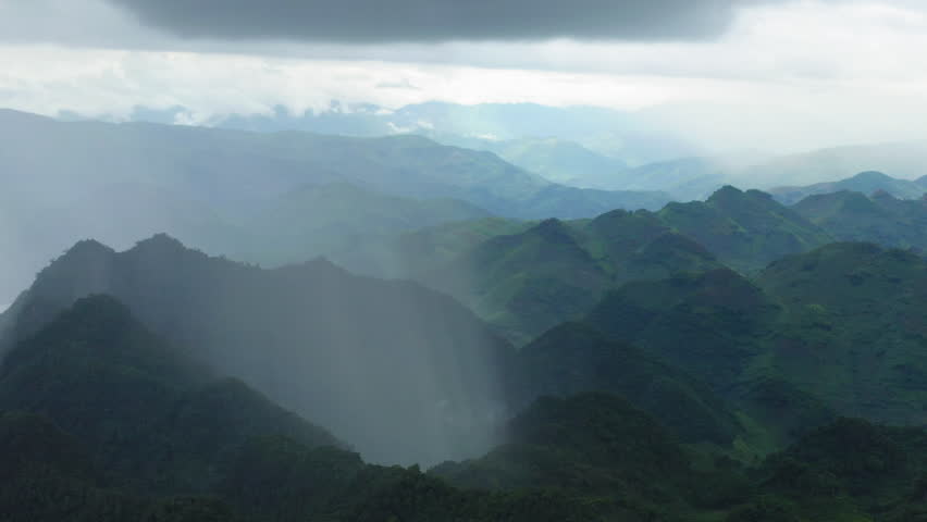 Sow drone orbit and wide aerial capture the scale of a rain shaft—a localized vertical column of heavy precipitation—impacting high-plateau rapids and waterfalls
in Mộc Châu District, Sơn La, Vietnam