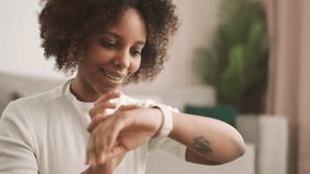 Modern technology for people life, portrait of black woman using smartwatch. African american female person viewing notification on screen of her smart band, athletic lady inputting sport index - Powered by Shutterstock - Get 15% off with code: PIKWIZARD15