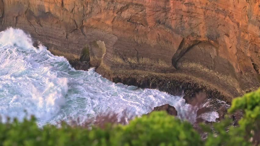Close up of waves pushing towards sea cliff, Loch Ard Gorge, Great Ocean Road, Port Campbell, Victoria, Australia