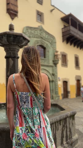 Woman in a colorful dress in front of Christopher Columbus's house in the city of Las Palmas, Vegueta neighborhood, Gran Canaria