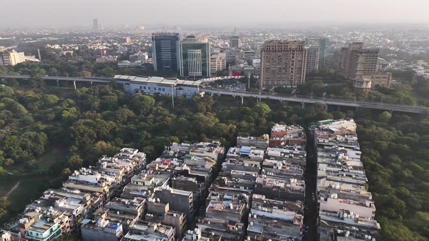Okhla NSIC Metro station seen from above, bridging forests and city blocks—an iconic view of Delhi’s rapid transit network woven into its urban landscape.