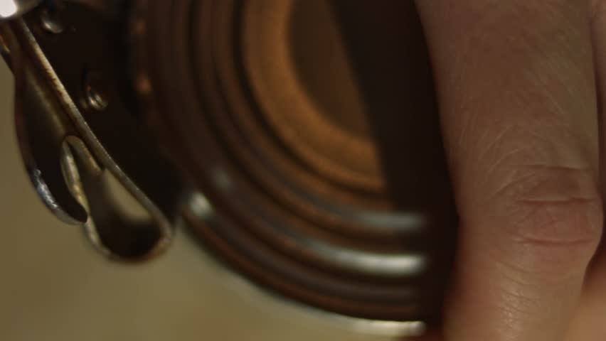 Opening a can with a manual can opener