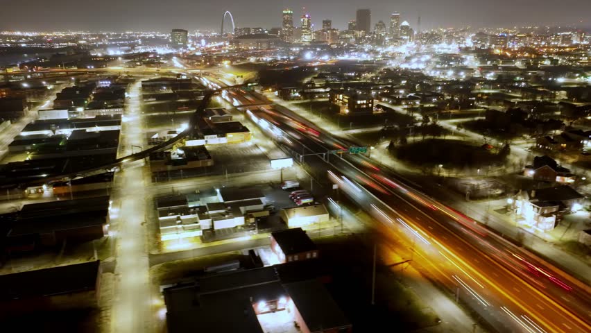 Time lapse view of traffic moving left to right over Interstate 70 in St Louis Missouri. Urban highway transportation scene showing city infrastructure and commuter flow.