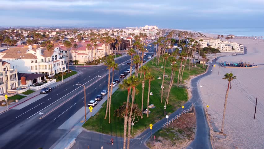 Coastal view of Huntington Beach Orange County California, Pacific West Coast, surfing waves, sandy beaches, sunny summer day. Aerial Landscape looking north toward HB Pier.
