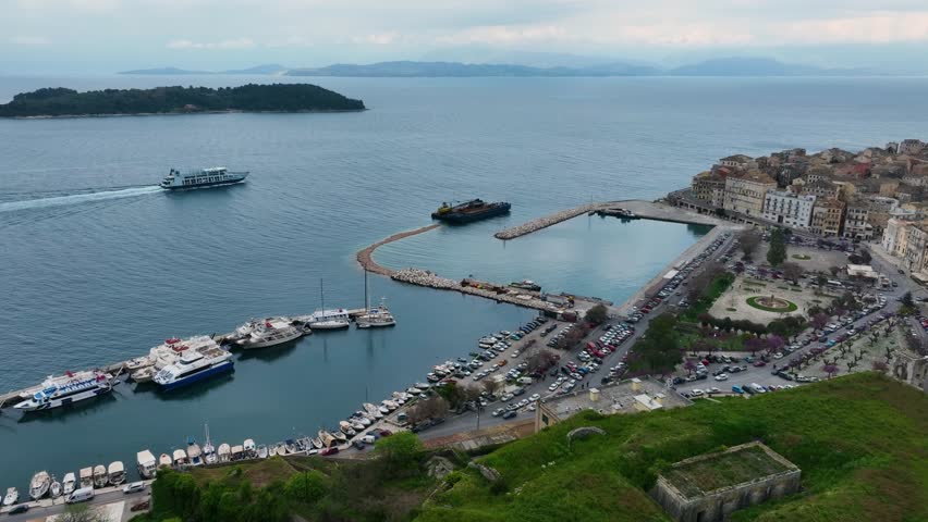 Aerial Drone View of Corfu Old Port with Boats Yachts and Ferry Traffic near Historical City Walls and Park