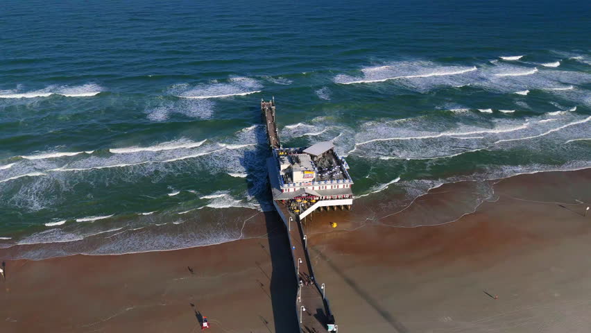 Drone view of Daytona Beach Florida pier and Atlantic Ocean waves