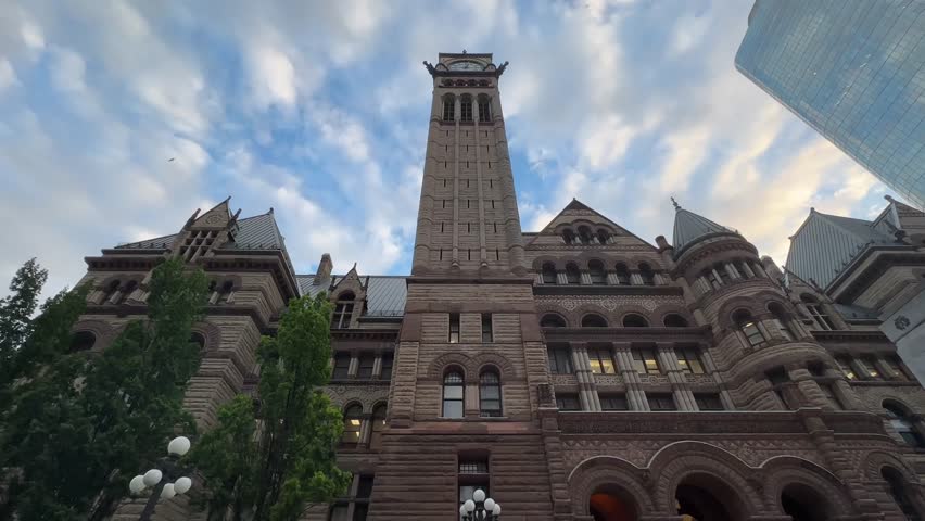 Ground View Capturing Toronto Downtown With Moving Traffic High Rise Buildings And People Walking Through The Bustling Urban Streets On A Warm Sunny Day In Canada