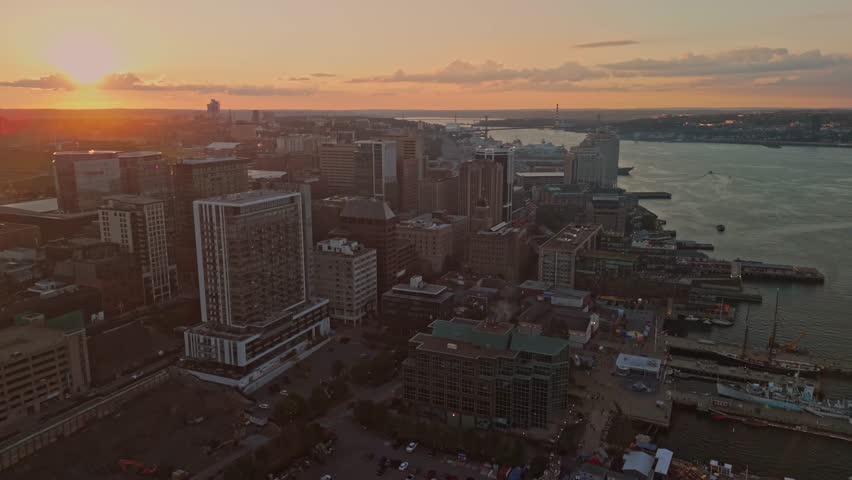Drone View Highlights Halifax Nova Scotia Canada With Bright Summer Sun Modern Skyscrapers Busy Waterfront Paths And Yachts Along The Marina Creating A Lively Coastal Atmosphere