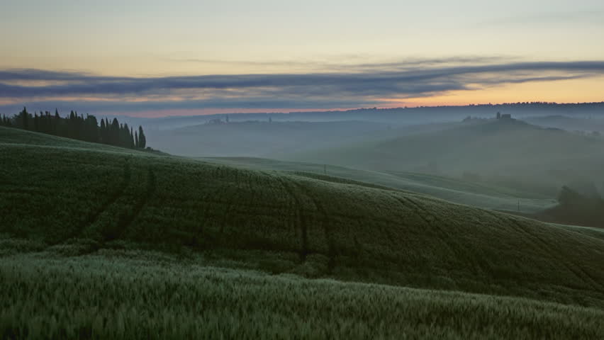 Tuscany landscape at sunrise with farm house and hills, Italy, timelapse