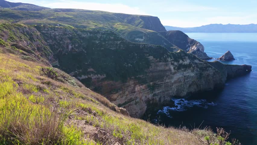 Sweeping panoramic view of the rugged volcanic cliffs and deep blue waters of the Santa Barbara Channel from the Cavern Point overlook