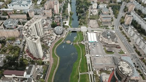 Drone Rotating Upward over Urban River Valley