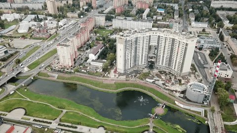 Drone Rotating above Urban River Landscape