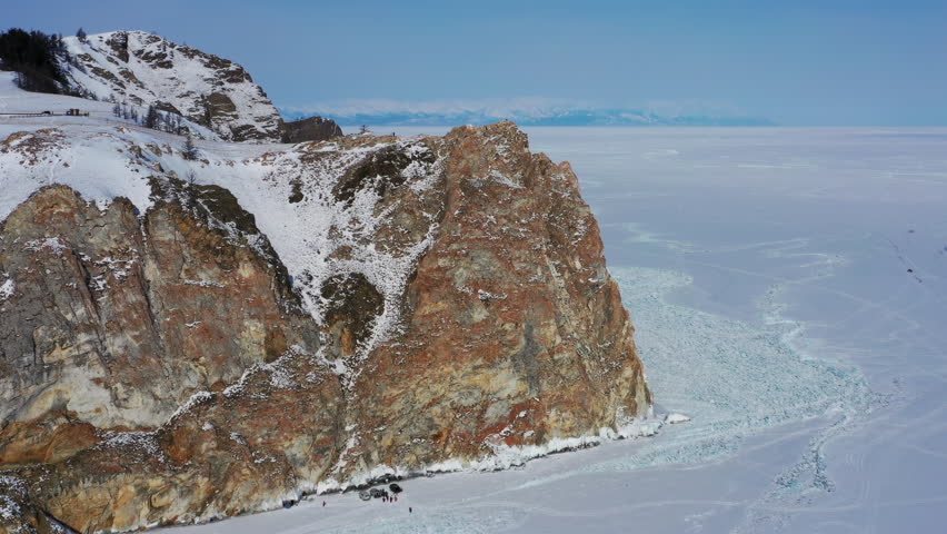 Aerial view of frozen Lake Baikal, Olkhon Island, Rock cape. Siberia, Russia, 4k