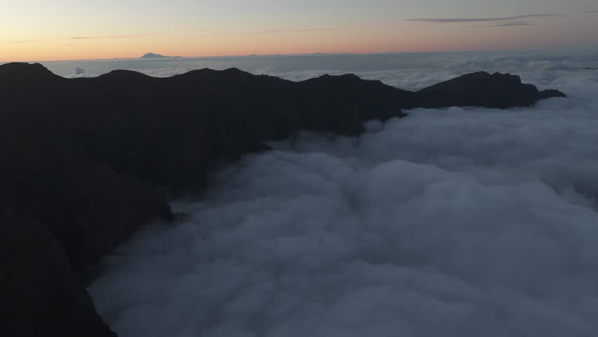 Aerial footage of the Caldera de Taburiente above a sea of clouds in La Palma, Canary Islands