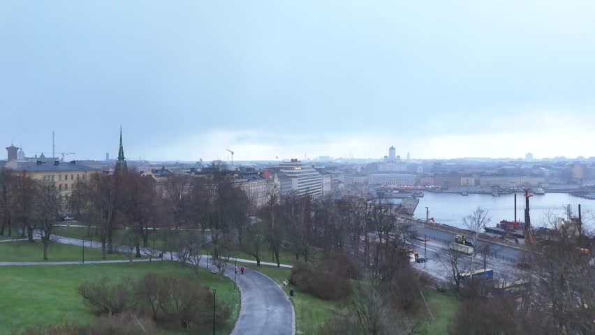 Helsinki 24.11..2025 drone shot from Tähtitornimäki to Helsinki Market Square, there is increasing snowfall in the air