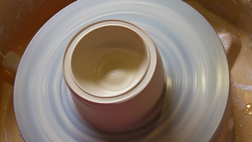 Top View of Potter Hands Shaping Clay on a Spinning Wheel