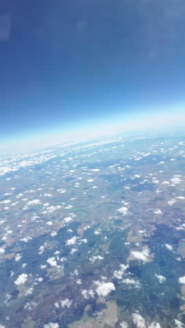 Highaltitude aerial journey over expansive landscape under clear sky