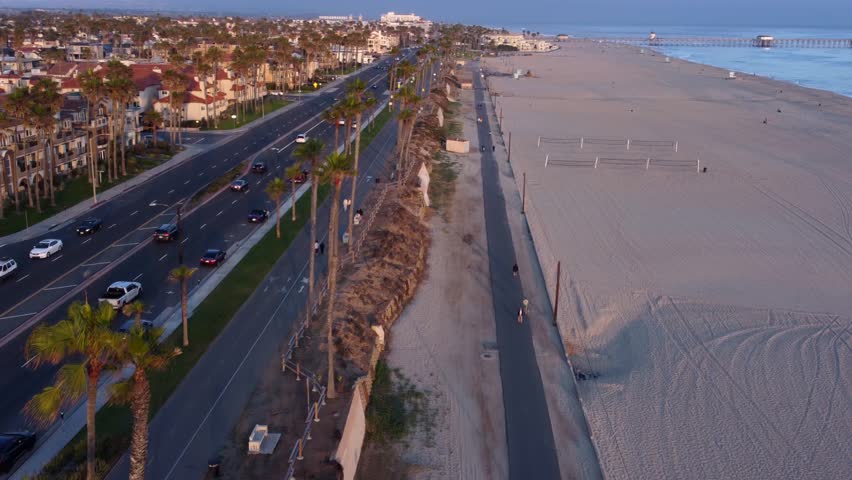 Coastal view of Huntington Beach Orange County California, Pacific West Coast, surfing waves, sandy beaches, summer evening. Aerial Landscape looking toward HB Pier.