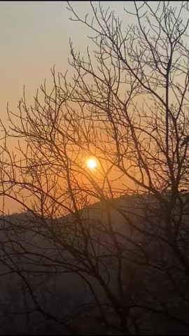 A breathtaking sunset over Islamabad, Pakistan, casting warm golden hues across the skyline with dramatic clouds and the silhouette of the iconic Margalla Hills. Perfect for travel, nature, and hiking