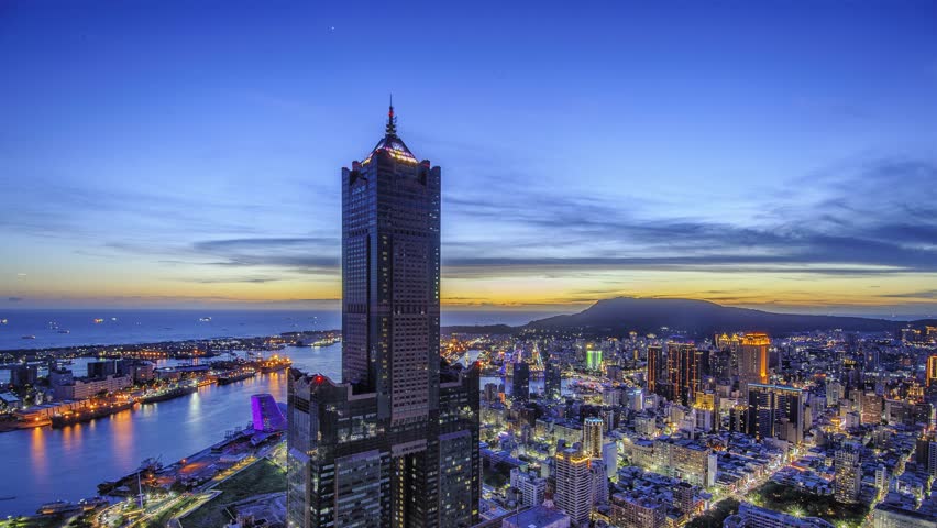 Aerial view of Kaohsiung 85 Sky Tower and Kaohsiung Harbor at sunset, Taiwan cityscape.