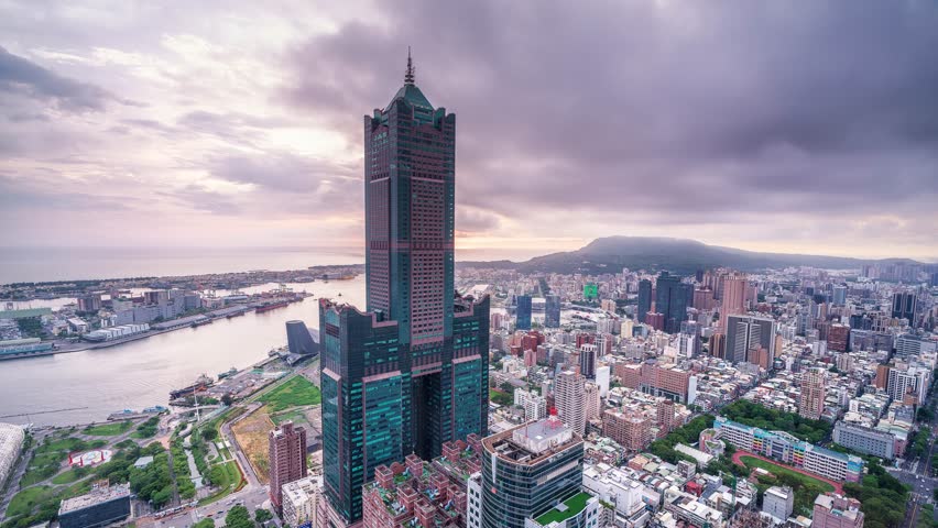 Aerial view of Kaohsiung 85 Sky Tower and Kaohsiung Harbor at sunset, Taiwan cityscape.