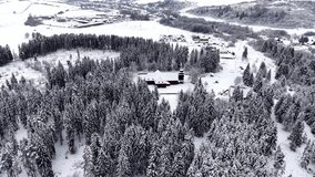 Aerial overhead drone footage of a snow covered church roof forming a clear cross shape in winter conditions in the village of Svaty Kriz, Liptov, Slovakia. Minimalist composition and calm winter mood. - Powered by Shutterstock - Get 15% off with code: PIKWIZARD15