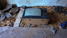 Old CRT television abandoned in derelict barn on straw inside rural farm interior forgotten dusty vintage - Powered by Shutterstock - Get 15% off with code: PIKWIZARD15