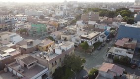 Sunrise over city rooftops, Sunlit neighborhood scene with narrow streets and sparse traffic at dawn - Powered by Shutterstock - Get 15% off with code: PIKWIZARD15