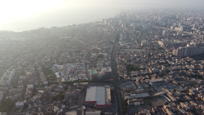 Drone cityscape overview, Lima suburbs from above, Aerial shot highlighting urban and coastal features