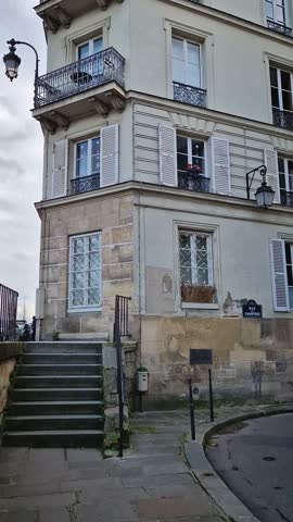 Quiet and historic parisian corner on the ile de la Cite, at the intersection of Rue des Ursins and Rue des Chantres. Reconstructed medieval style buildings with a distinct gothic arched doors