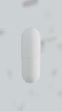 Animation of white medicine capsule opening and remedy particles fly out on white backdrop. Medical research, science concept. 3d render Vertical video - Powered by Shutterstock - Get 15% off with code: PIKWIZARD15