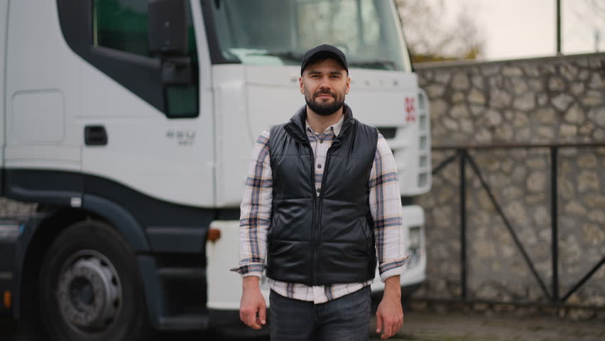 Confident truck driver walking towards camera