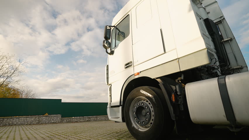 Truck driver finishing work and getting out of his semi truck