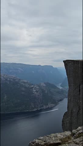 View Over Someone or traveller Getting Photographed at Preikestolen, Norway, with a Scenic View.