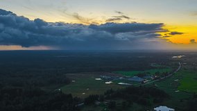 Aerial timelapse of storm clouds sweeping over rural fields at sunset, showing dramatic sky movement, shifting light, and approaching rain over the countryside. - Powered by Shutterstock - Get 15% off with code: PIKWIZARD15