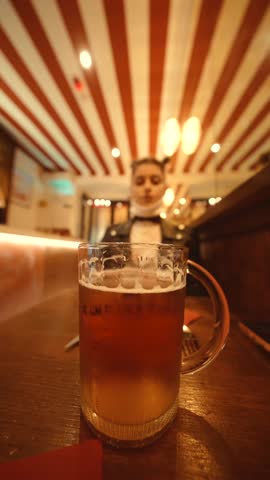 Intimate shot of female evaluating craft ale in pub setting