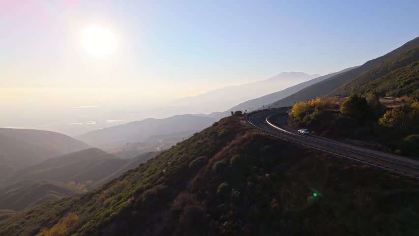 Low aerial orbit of Panorama Point along the Rim of the World Scenic Byway with colorful autumn foliage and majestic mountains in the San Bernardino National Forest