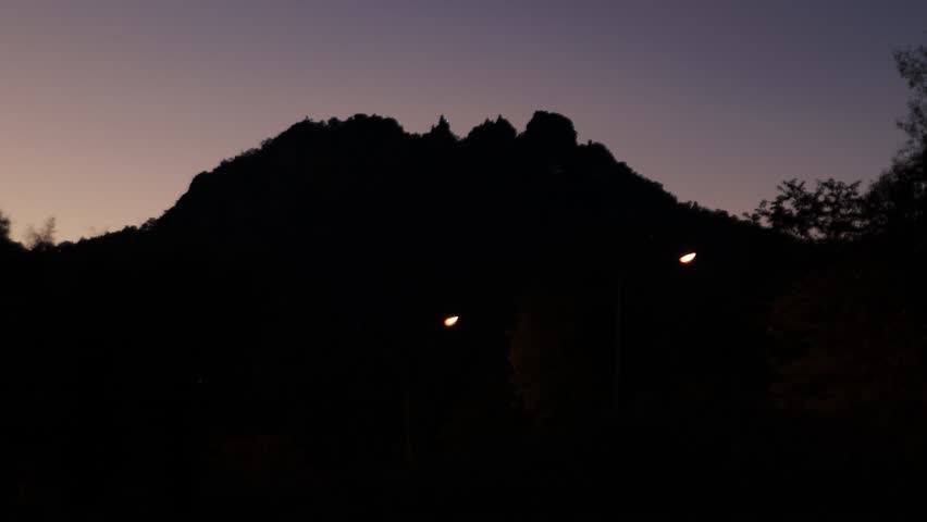 A nighttime video view from a high mountain, showing the moon and the cool winter air. The air is calm and pleasantly cool during this nature trip.
