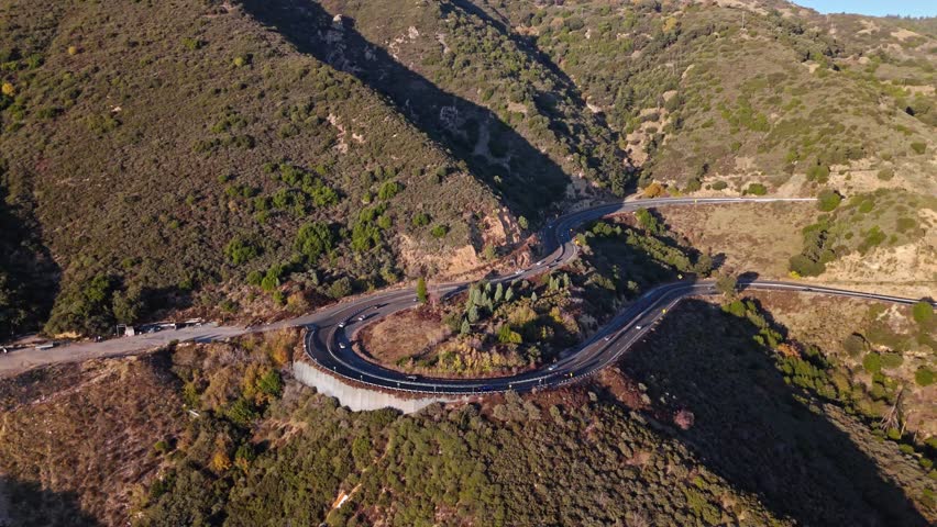 High aerial orbit of Panorama Point along the Rim of the World Scenic Byway with colorful autumn foliage and majestic mountains in the San Bernardino National Forest