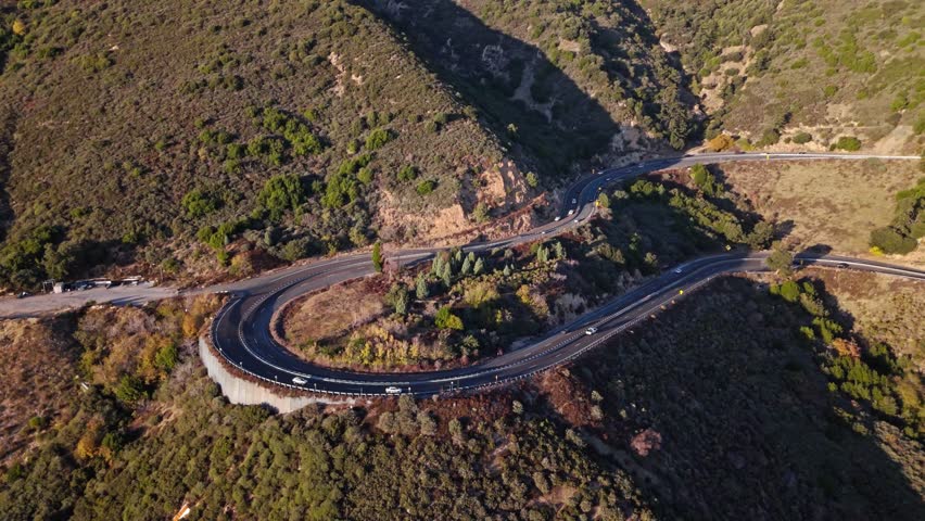 High aerial orbit of Panorama Point along the Rim of the World Scenic Byway with colorful autumn foliage and majestic mountains in the San Bernardino National Forest