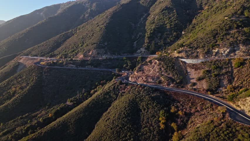 High aerial orbit of Panorama Point along the Rim of the World Scenic Byway with colorful autumn foliage and majestic mountains in the San Bernardino National Forest