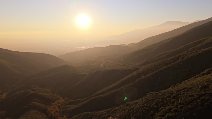 Aerial flyover of Panorama Point along the Rim of the World Scenic Byway at golden hour with colorful autumn foliage and majestic mountains in the San Bernardino National Forest