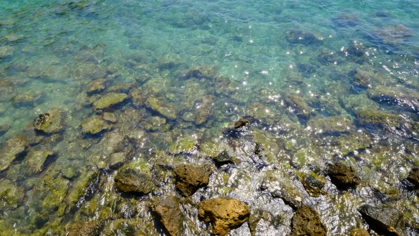 Ocean Waves Crashing Against Coastal Rocks. Sea Waves Hitting Rocky Shoreline. Natural Seascape with Waves Striking Rocks.