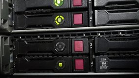 Close-up footage of green rotating LED indicator lights on server storage, signaling active operation inside a modern data center room with advanced network and digital infrastructure. - Powered by Shutterstock - Get 15% off with code: PIKWIZARD15