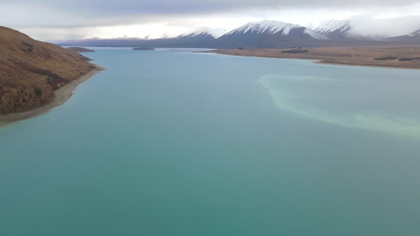 Aerial static hover view of Lake Tekapo and mountains in South Island, New Zealand