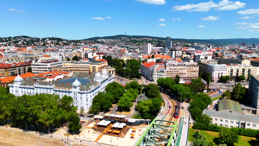 Trams move by the roads in the city canter of Bratislava, Slovakia. Aerial perspective on the old part with historical architecture.