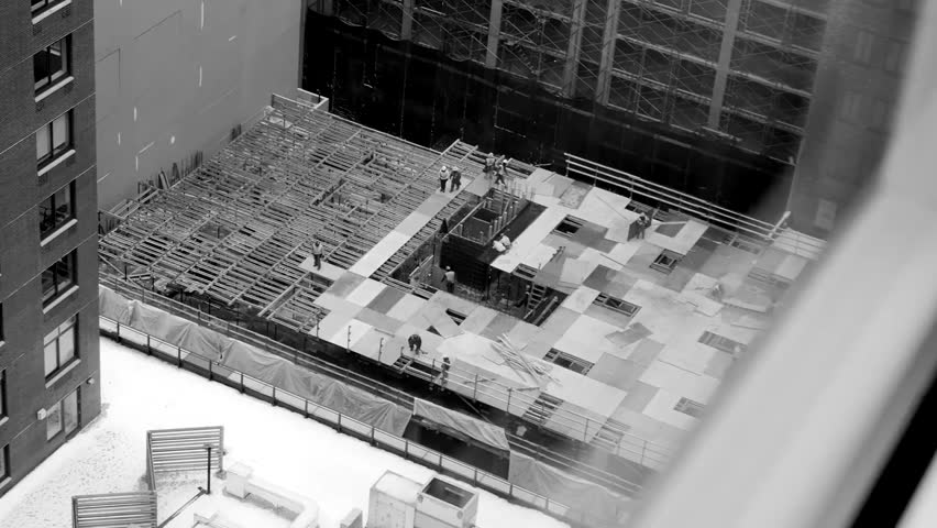 Black and white time-lapse of construction workers at a site, showcasing fast-paced building activity, teamwork, industrial labor, and construction process.