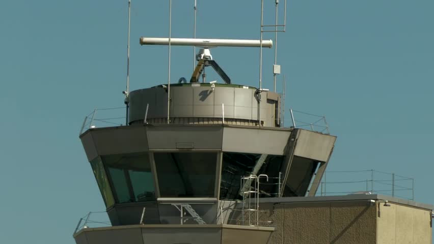 Air traffic control tower monitoring planes landing, showcasing airport operations, aviation safety, and modern air traffic management in real time.
