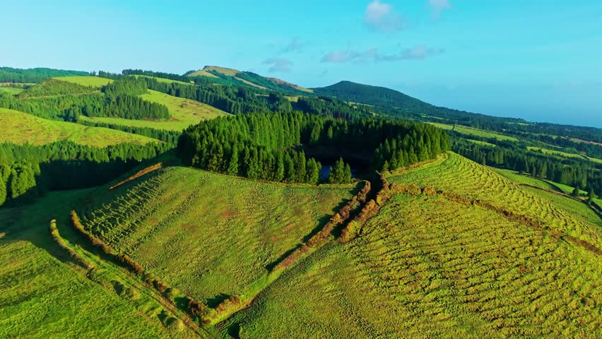 Aerial view of the unique landscape of Sao Miguel Island with a small lake in the volcano caldera Lagoa de Pau Pique, Azores, Portugal.